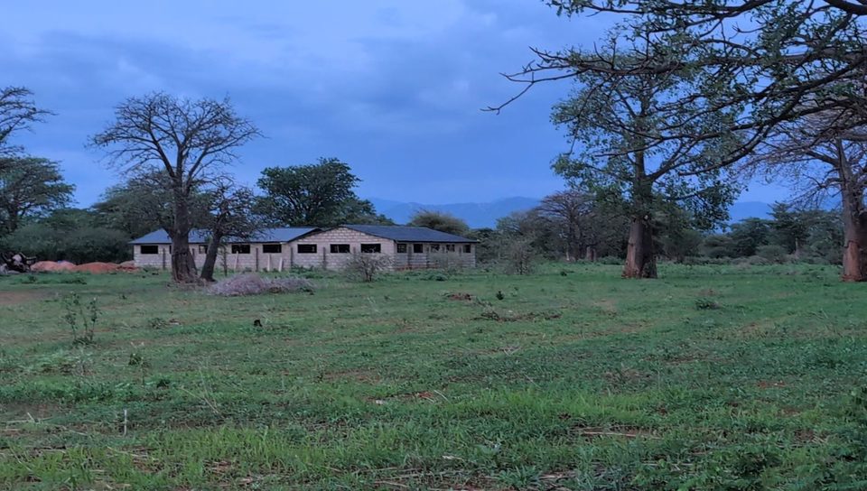 The farm's houses with the hills behind